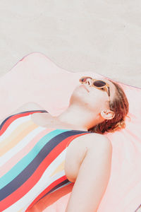 High angle view of young woman sitting at beach