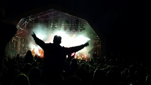 People enjoying music concert at night