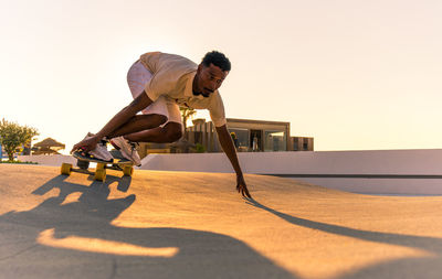 Side view of man exercising at beach