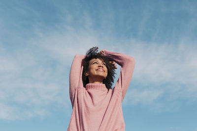 Portrait of happy young woman enjoying sunlight