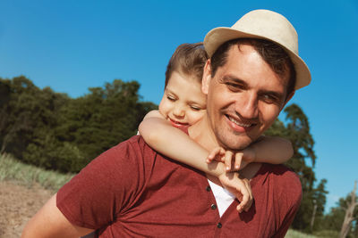 Portrait of smiling man and woman against sky