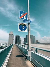 Road sign against sky