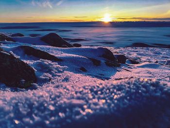 Scenic view of fogg sea against sky during sunrise