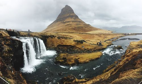 Scenic view of waterfall against sky