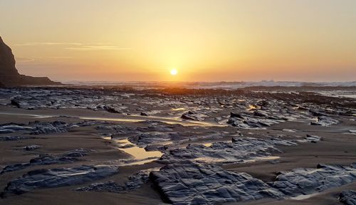 Scenic view of frozen lake during sunset