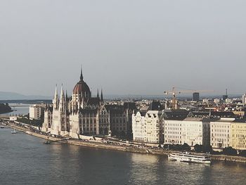 River amidst buildings against sky in city