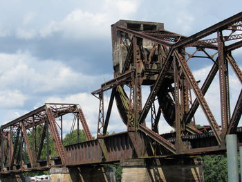 Low angle view of abandoned bridge against sky