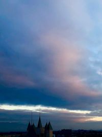 Low angle view of silhouette buildings against sky at sunset