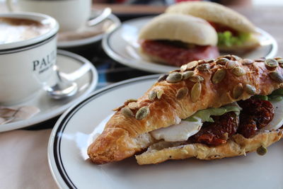 Close-up of food served by coffee on table