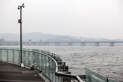 Distant view of dongjak bridge over han river seen from promenade