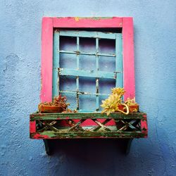 Close-up of window on red wall