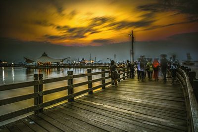 Pier on sea during sunset