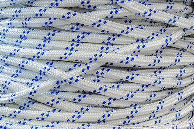 Full frame shot of white climbing rope with blue patterns