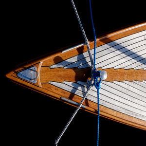 Directly above view of ropes tied to boat in water