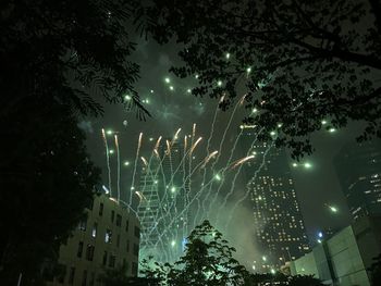 Low angle view of firework display at night