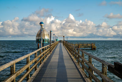 Pier over sea against sky