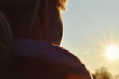 Close-up of woman against sky during sunset