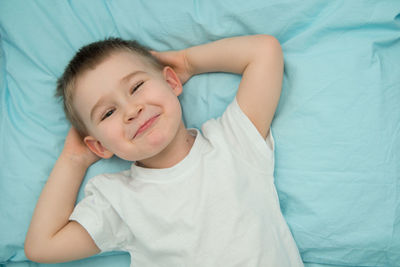 High angle view of baby lying on bed