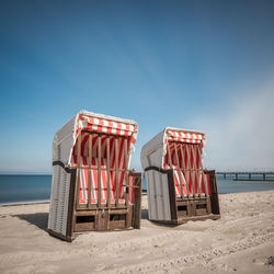 Lifeguard hut on beach against clear blue sky