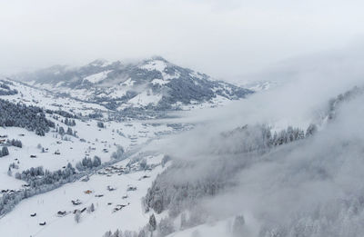 Scenic view of snow covered mountains against sky