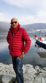 Man standing by sea against sky