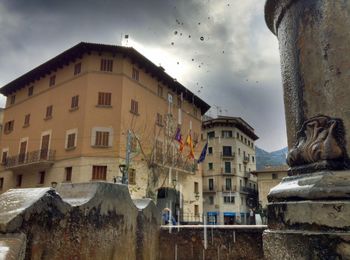 Buildings in town against sky