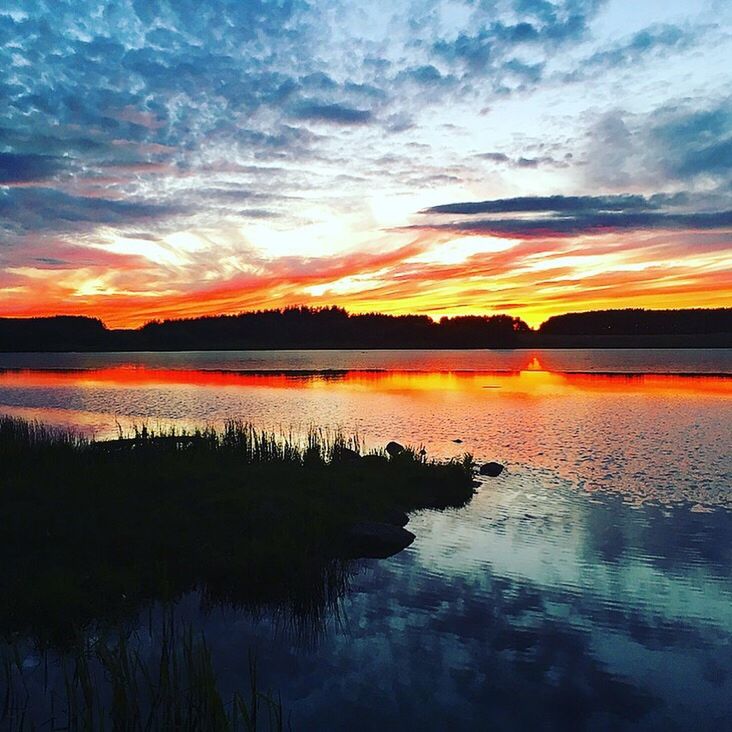 sunset, scenics, water, tranquil scene, tranquility, reflection, beauty in nature, orange color, lake, idyllic, cloud - sky, nature, sky, non-urban scene, majestic, mountain, calm, outdoors, romantic sky, dramatic sky, no people, atmospheric mood, moody sky, multi colored, standing water, waterfront, countryside, remote