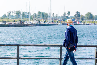 Man looking at view while walking against baltic sea