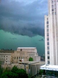 Buildings against cloudy sky