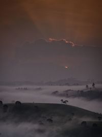 Scenic view of silhouette mountain against sky during sunset