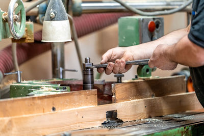 Cropped hand of man working at workshop