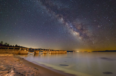 Scenic view of sea against star field