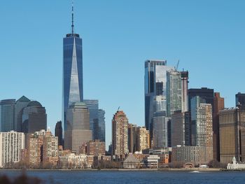 Buildings in city against clear sky