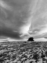 Storm clouds over snow covered landscape