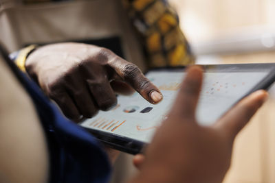 Midsection of woman using mobile phone