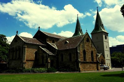 Buildings against cloudy sky
