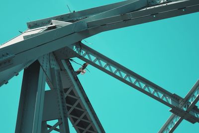 Low angle view of bridge against clear blue sky