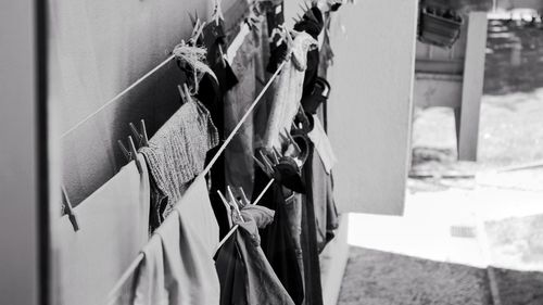 Close-up of clothes drying on clothesline against wall