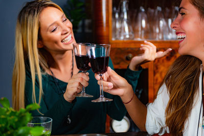 Happy friends toasting drinks