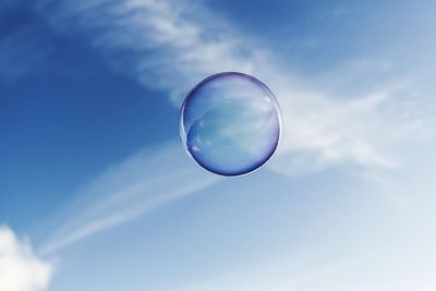 Low angle view of bubbles against sky