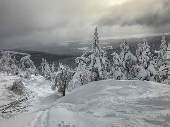 Scenic view of snow covered landscape against sky