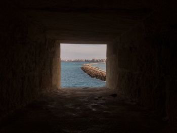 Scenic view of sea seen through archway