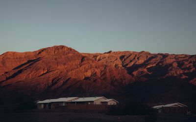 Houses on mountain against clear sky