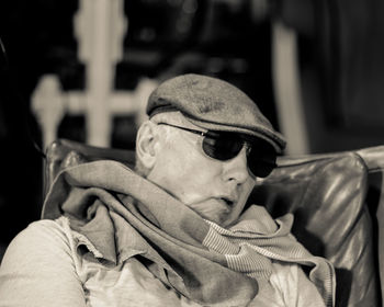 Senior man wearing sunglasses relaxing on chair