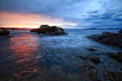 Scenic view of sea against cloudy sky