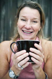 Smiling mature woman with mug, sweden