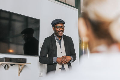 Smiling businessman in meeting with colleagues at office