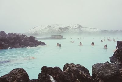 People bathing in blue lagoon