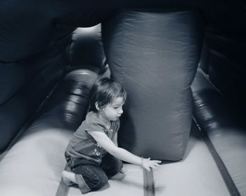 Side view of girl plying in bouncy castle