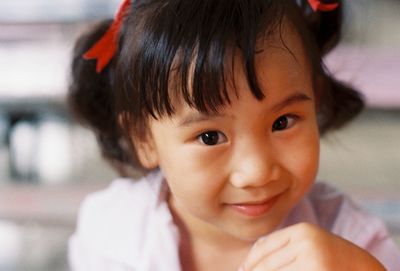 Close-up portrait of cute girl smiling
